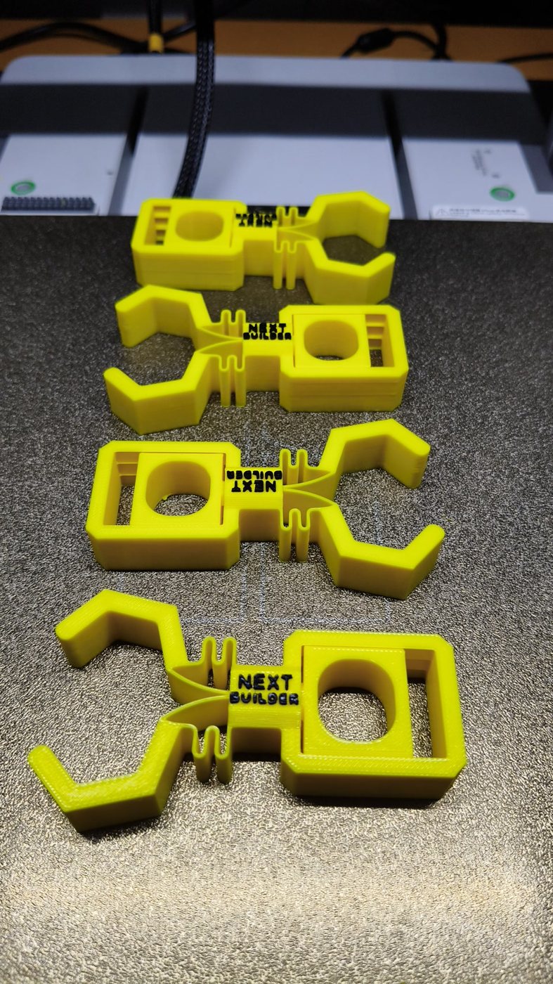 3D-printed parts stamped with the NextBuilder name