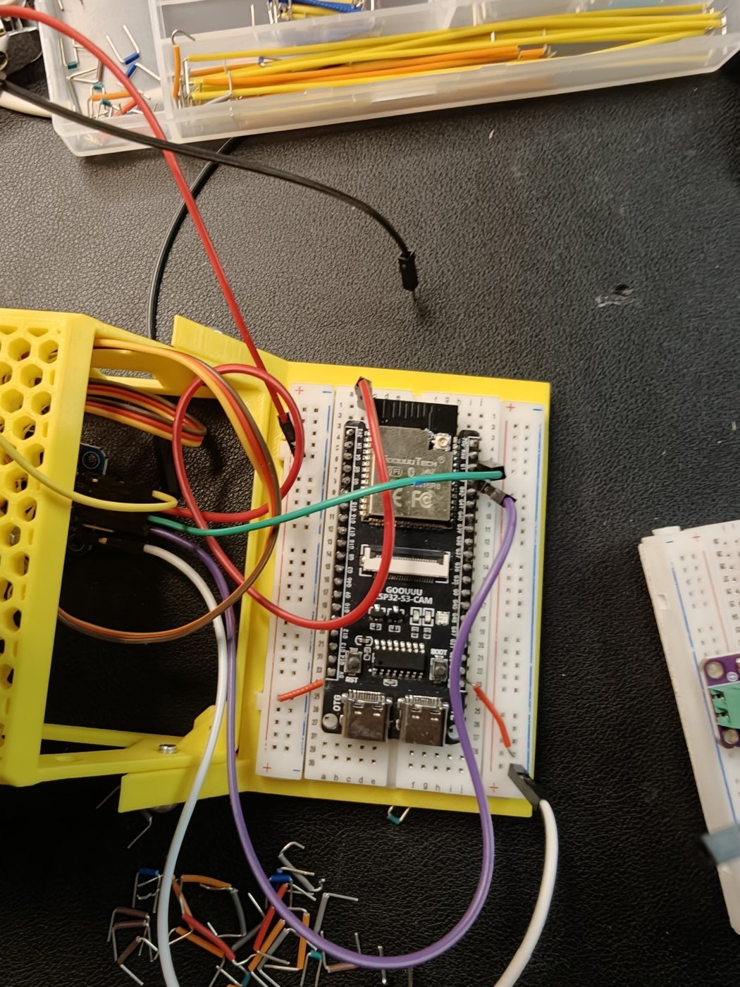 A student-built robot body with a microcontroller and colour-coded wiring
